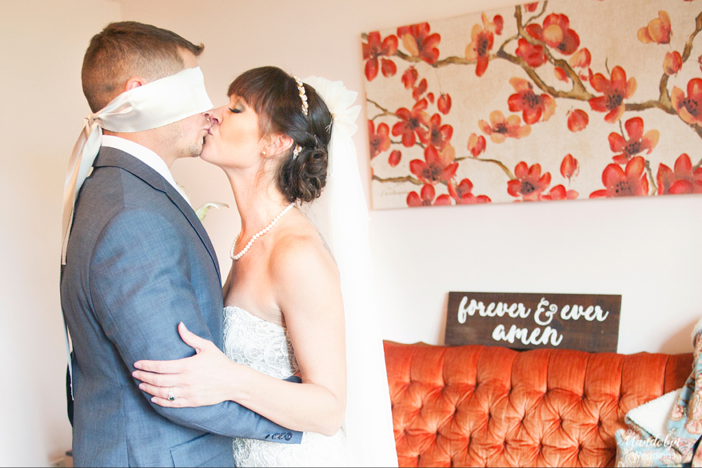 The bride and groom meet before the ceremony for the first look. The groom is blindfolded. 