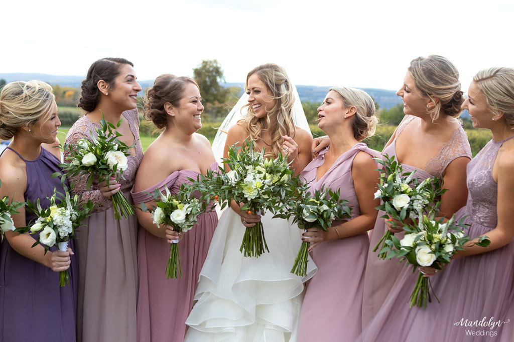 The bride and her bridesmaids laughing. 